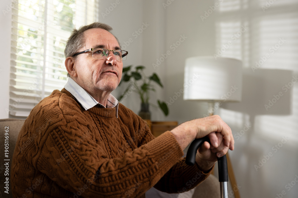 Fototapeta premium Elderly man sitting thoughtfully at home