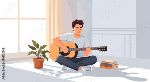 Man playing acoustic guitar while sitting on the floor.