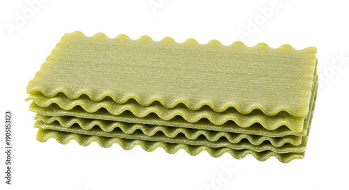 Stack of green spinach lasagna noodles dry pasta sheets with wavy edges isolated on white background for Italian cuisine and recipes