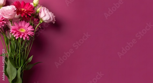 A bouquet of pink and red flowers on a purple background