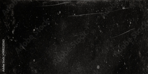 A dark grainy abstract texture with scattered white specks and subtle linear streaks across the frame