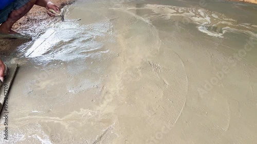 Construction Worker Leveling Cement Surface