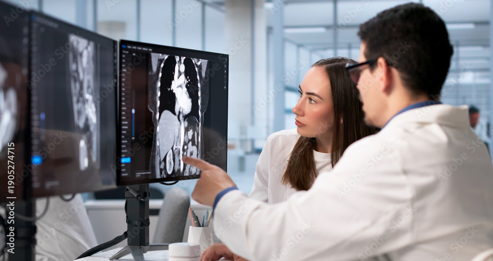 Naklejka premium Surgeon And Technician Examine X-ray