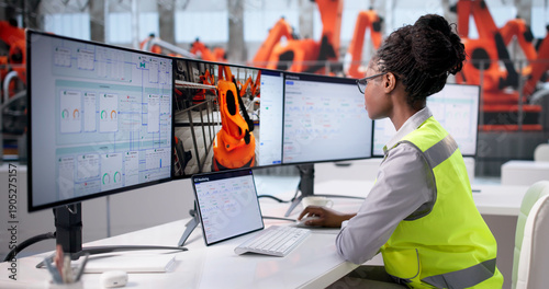 Tableau sur toile Designing Cars: African American Woman Engineers Robots