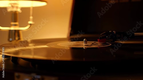 Vinyl record playing near warm lamp.