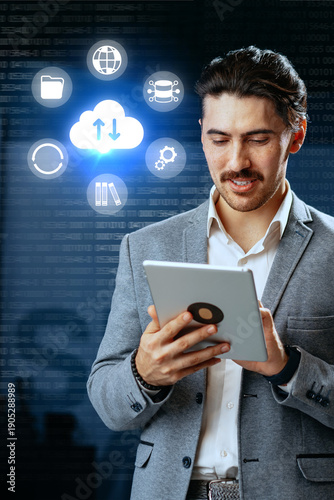 Businessman using tablet for cloud technology and data management in a modern office setup