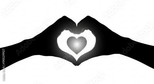Hands forming a heart shape with fingers around a glowing heart symbol