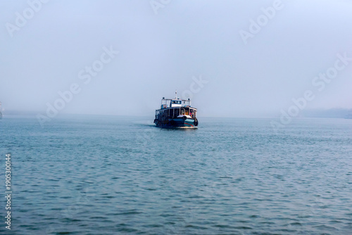 Canvas Print Passenger ferry coming over blue sea and sky horizon