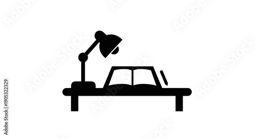 Desk lamp illuminating an open book on a table.