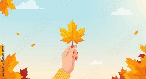 Hand holds vibrant yellow autumn leaf against soft sky and clouds