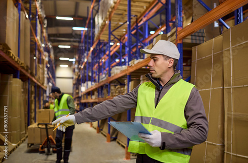 Bilde på lerret Warehouse logistics worker checks inventory and storage