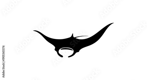 Silhouette of a Manta Ray swimming gracefully in the ocean.