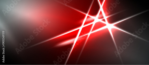 Abstract red light streaks intersect dark background. Brightness creates dynamic visual effect, energy radiates outward.