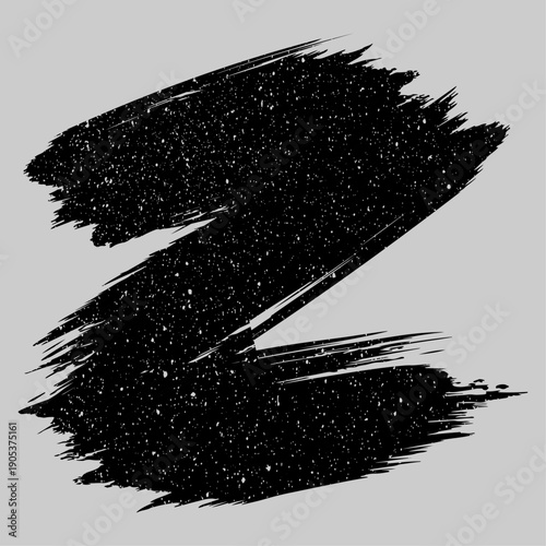 A dynamic black brushstroke with a textured speckled appearance against a neutral gray background