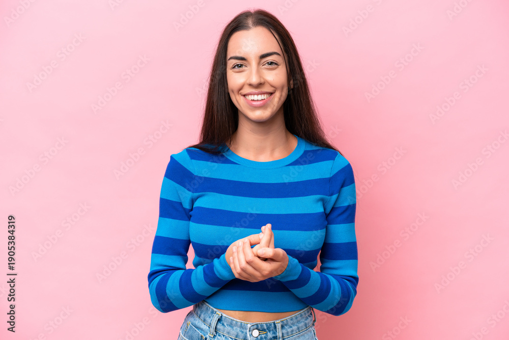 Obraz premium Young caucasian woman isolated on pink background laughing