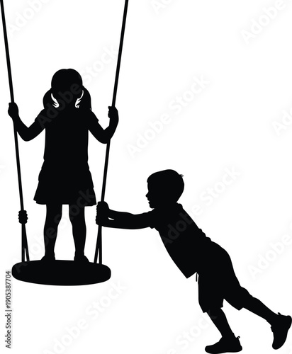 Silhouette of children playing together where a boy pushes a girl standing on a round swing, depicting happy childhood friendship and playground fun.