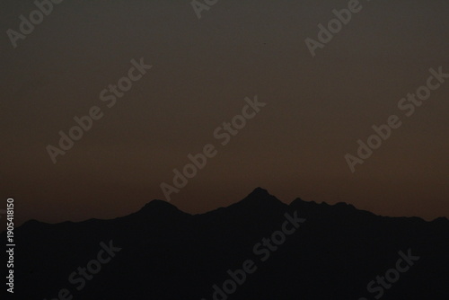 Mountain silhouettes against a dusky sky