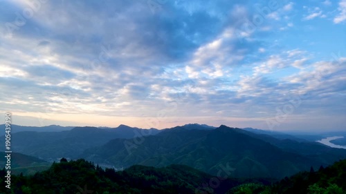 Alpine Mountain Valley with Dramatic Clouds and River