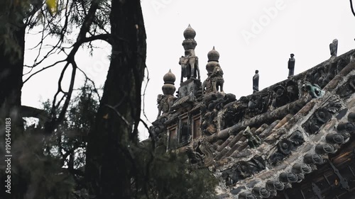 Ancient Asian Temple with Golden Domes and Ornate Roof Details