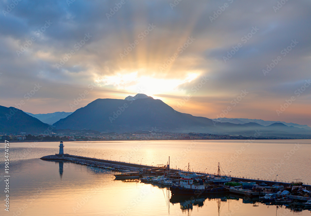 Obraz premium Alanya harbor and marina view from Alanya peninsula with lighthouse at amazing sunset - Alanya, Turkey