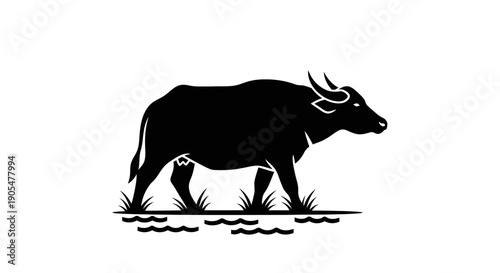 Black silhouette of a water buffalo standing in grass, isolated on a white background, representing strength and nature.