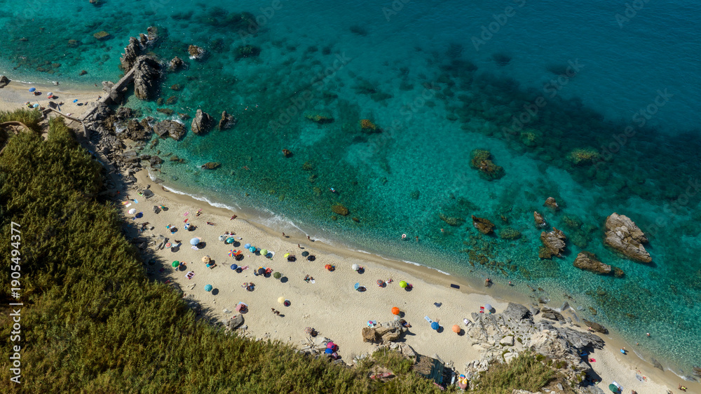Obraz premium Aerial view of Michelino Beach, located near Tropea, in province of Vibo Valentia, Calabria, southern Italy. This beautiful coastline overlooking the Tyrrhenian Sea is known as the Coast of the Gods.