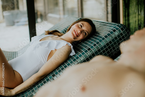 Woman relaxes beside a man ...