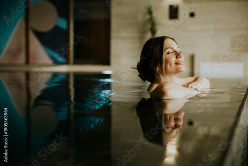 Woman relaxes in indoor swi...