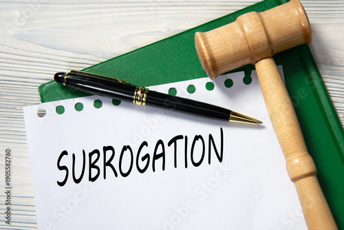 SUBROGATION - word in white paper against the background of a green folder and a judge's gavel