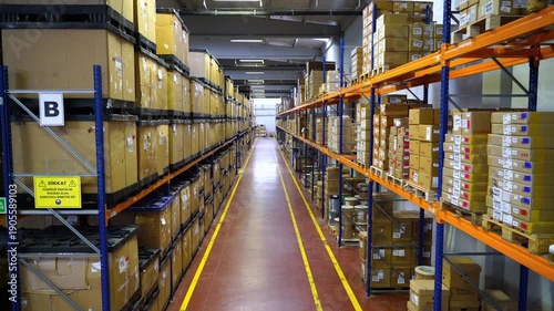 Drone footage moving backwards revealing a vast distribution center filled with cardboard boxes on high shelves. Concept of global e-commerce business, supply chain, and industrial storage.