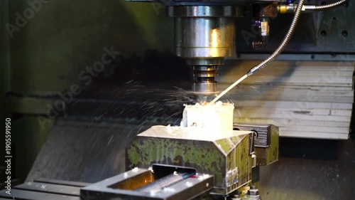 Real-time footage of industrial metalworking using liquid cooling on a lathe. Manufacturing economy concept showing machinery investment and engineering precision.
