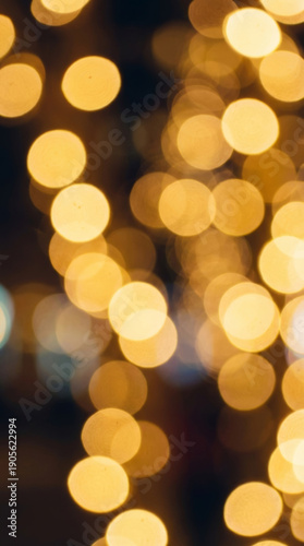 Shimmering gold bokeh lights create magical, festive celebration background. Warm abstract glow evokes joy and happiness. Soft out of focus circles form vibrant pattern, perfect for holiday events