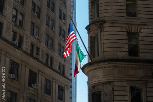 American and Italian Flags Flying Together on Urban Building Facade in New York City