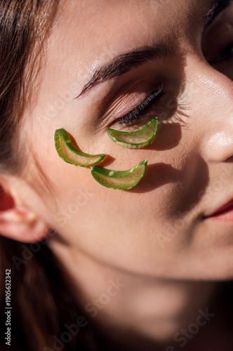 Wallpaper Mural Woman with natural beauty treatment using fresh aloe vera slices on her face, showcasing skincare routine and healthy lifestyle in a serene atmosphere Torontodigital.ca