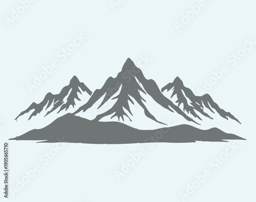 Grey silhouette of rugged mountain range with snow covered peaks