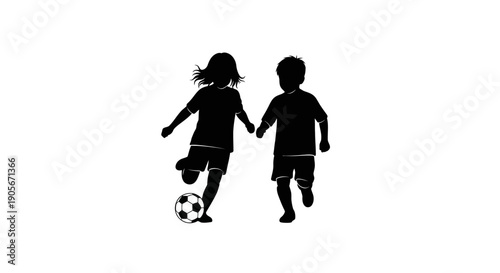 Silhouette of children playing soccer together.