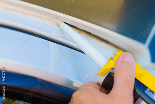 Applying silicon on caravan body