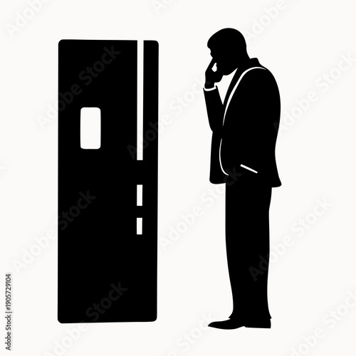 Businessman in silhouette talks on phone next to refrigerator