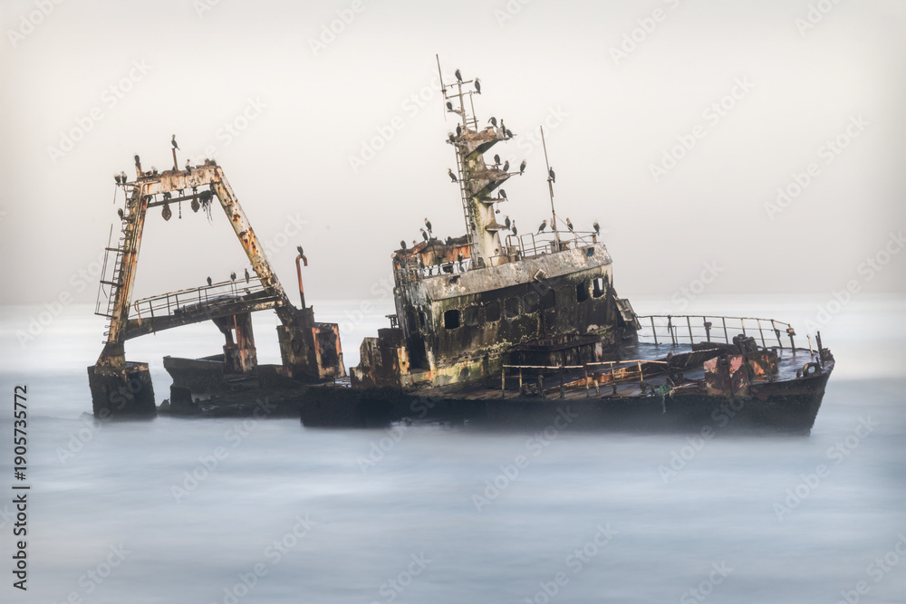 Fototapeta premium Abandoned Shipwreck Rusting in the Atlantic Ocean along the Skeleton Coast Namibia