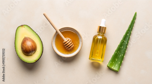 Flat lay of natural skincare ingredients with avocado, honey, oil, and aloe vera. Organic beauty products and DIY cosmetic concept. Top view of healthy ingredients on a neutral background