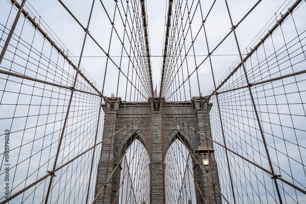 Fototapeta premium The scenic views of the Brooklyn Bridge, which is a cable-stayed suspension bridge in New York City, spanning the East River between the boroughs of Manhattan and Brooklyn.