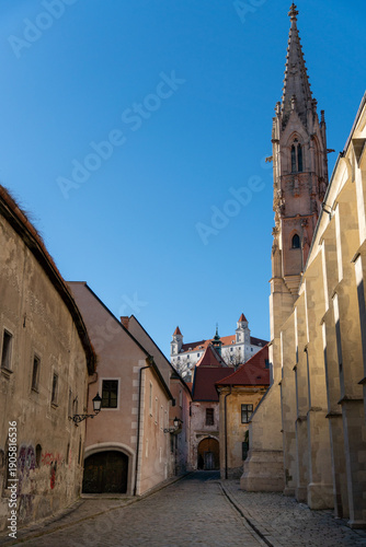 Photography Narrow street in old town Bratislava with medieval castle Bratislava in the background