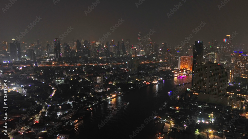 Fototapeta premium Skyscrapers in Bangkok city and river at night