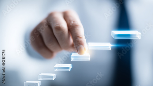Finger pressing transparent blocks forming a staircase to symbolize career advancement and business growth strategy.
