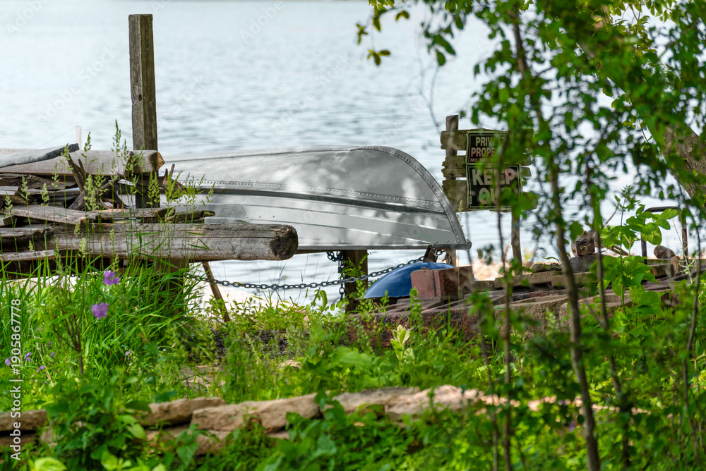 Fototapeta premium Aluminum Boat In Dry Dock Along The River In Summer In Wsconsin