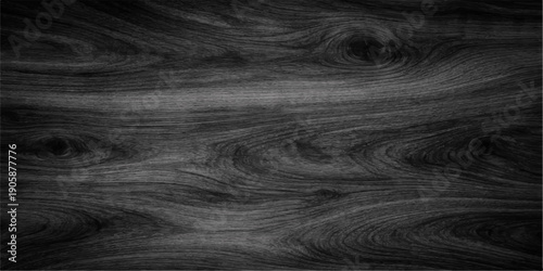 A dark natural oak wood grain texture features a black hardwood plank pattern with a deep brown timber surface and old organic tree material for a rustic wall or floor backdrop design