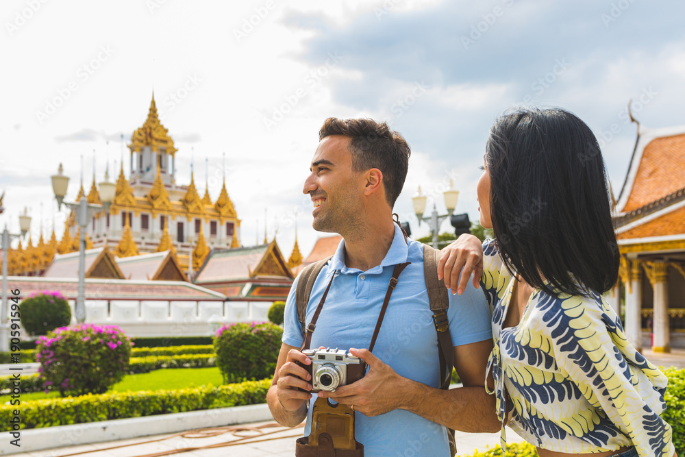 Fototapeta premium Tourist couple visiting Loha Prasat temple in Bangkok