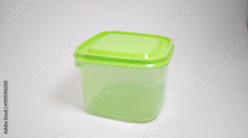 small transparent green storage box with solid green lid, white background