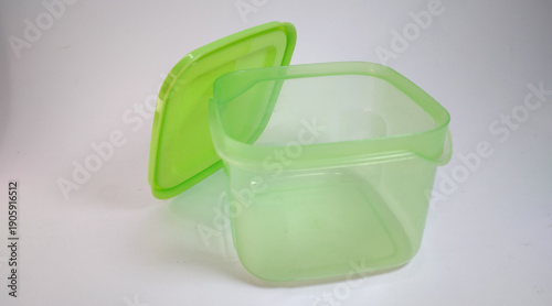 small transparent green storage box with solid green lid, white background