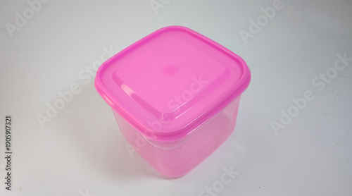 small transparent pink storage box with solid pink lid, white background